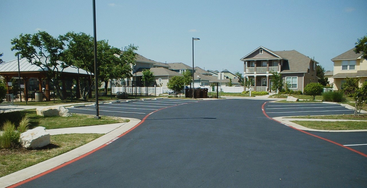 Freshly paved asphalt driveway by Integrity Paving and Coatings team