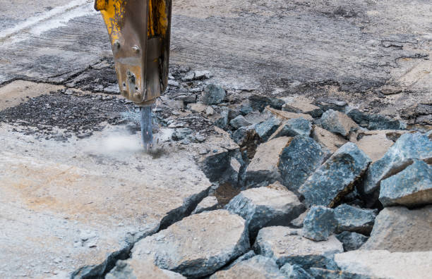 Concrete repair technician fixing cracked surface in New Braunfels TX driveway 