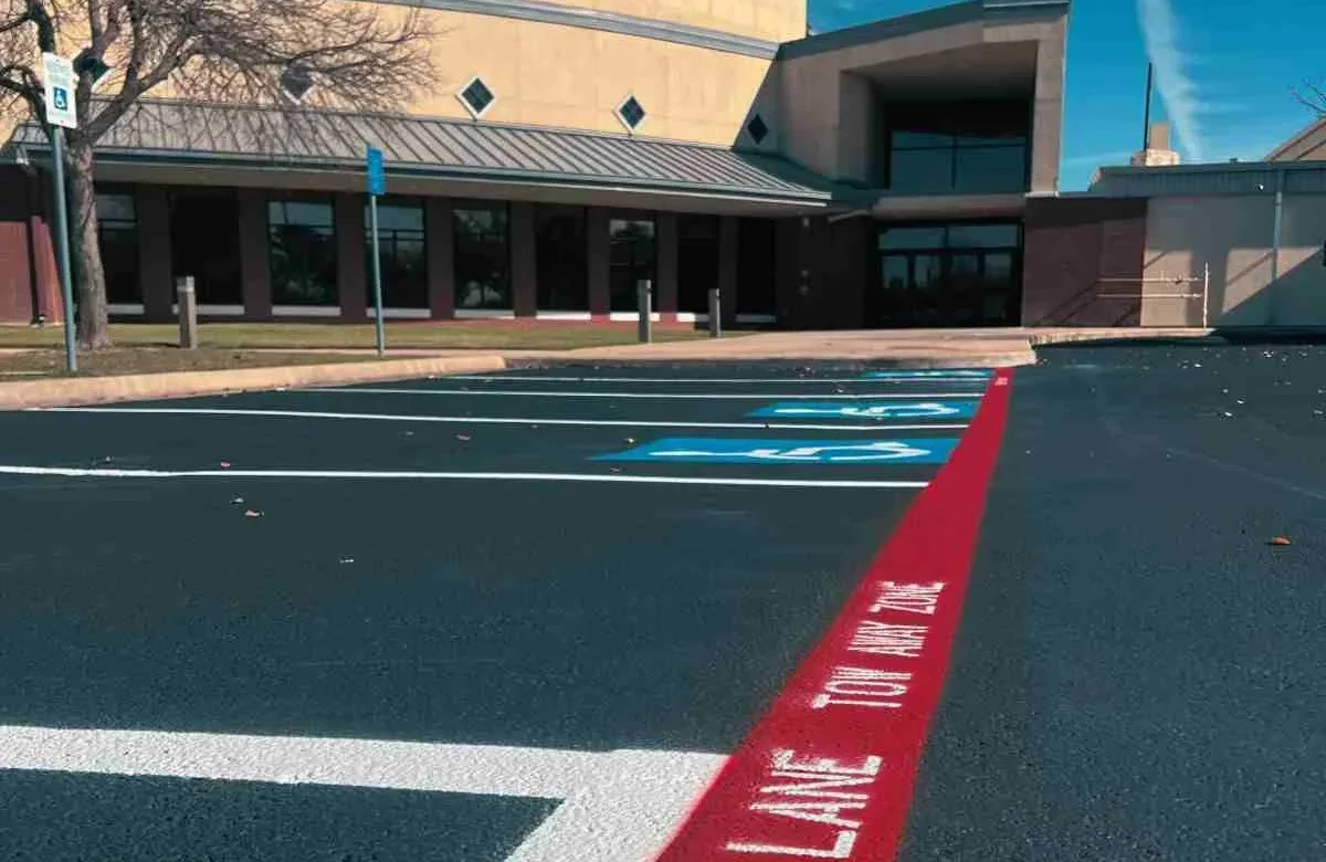 Newly striped commercial parking lot with organized parking spaces in Luling, TX.
