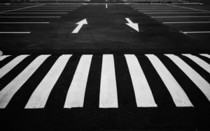 Parking space dimensions being measured for a striping layout in Bastrop, TX. Parking lot striping near me