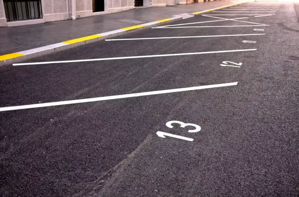 Parking lot line layout being measured before striping work in Kyle, TX. parking lot striping near me
