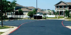 Integrity Paving and Coatings team reviewing a commercial parking lot striping project in Luling, TX. Parking lot striping near me