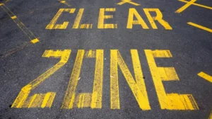 Painted lettering identifying designated spaces in a Wimberley, TX parking lot. parking lot striping near me